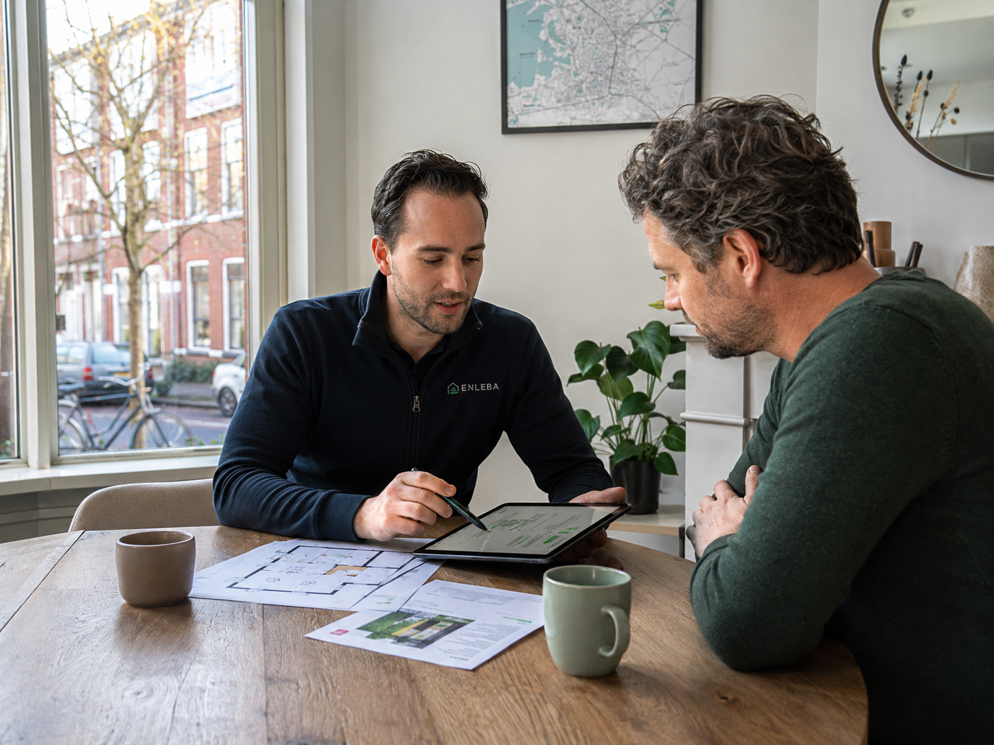 Enleba adviseur bespreekt maatwerkadvies met bewoner aan de keukentafel